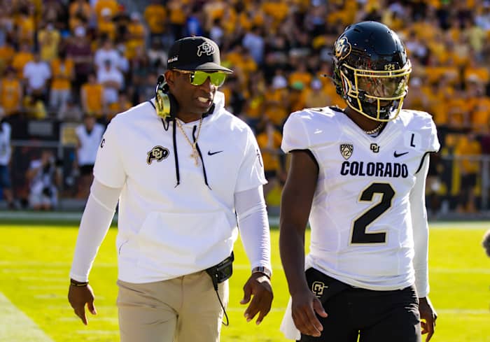 Colorado Buffaloes head coach Deion Sanders with son and quarterback Shedeur Sanders (2) against the Arizona State Sun Devils at Mountain America Stadium